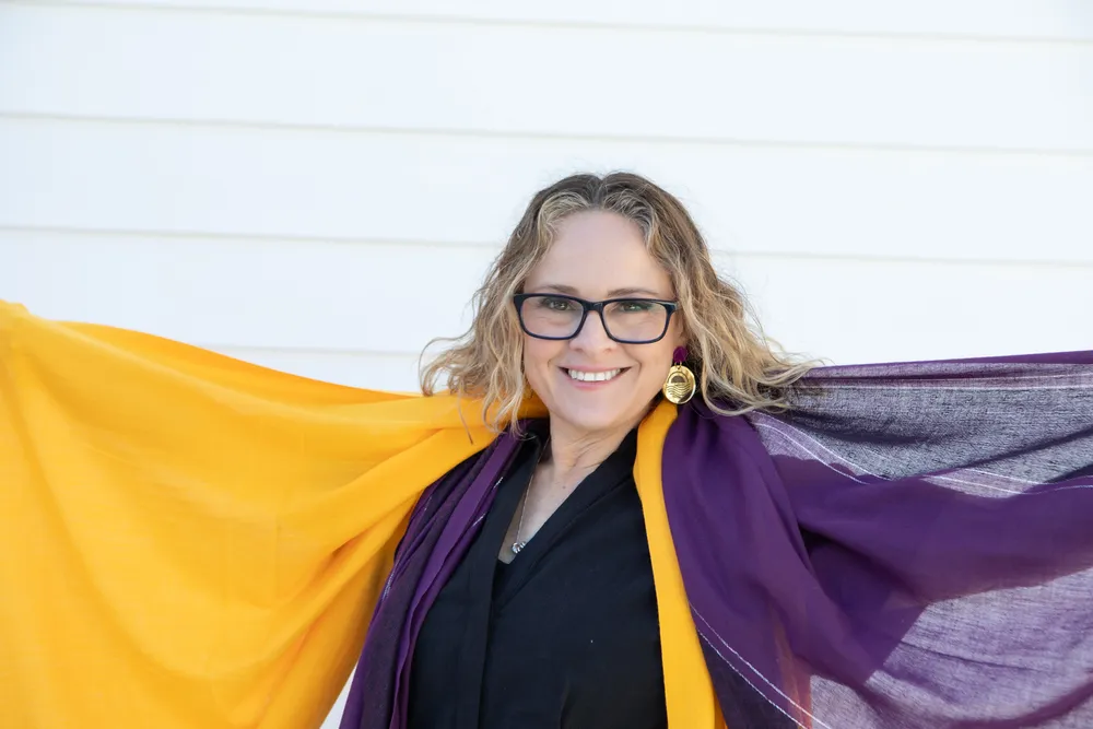 Melissa Murray, a woman in glasses and a purple and yellow scarf, embodies hope and understanding for families in need_11zon